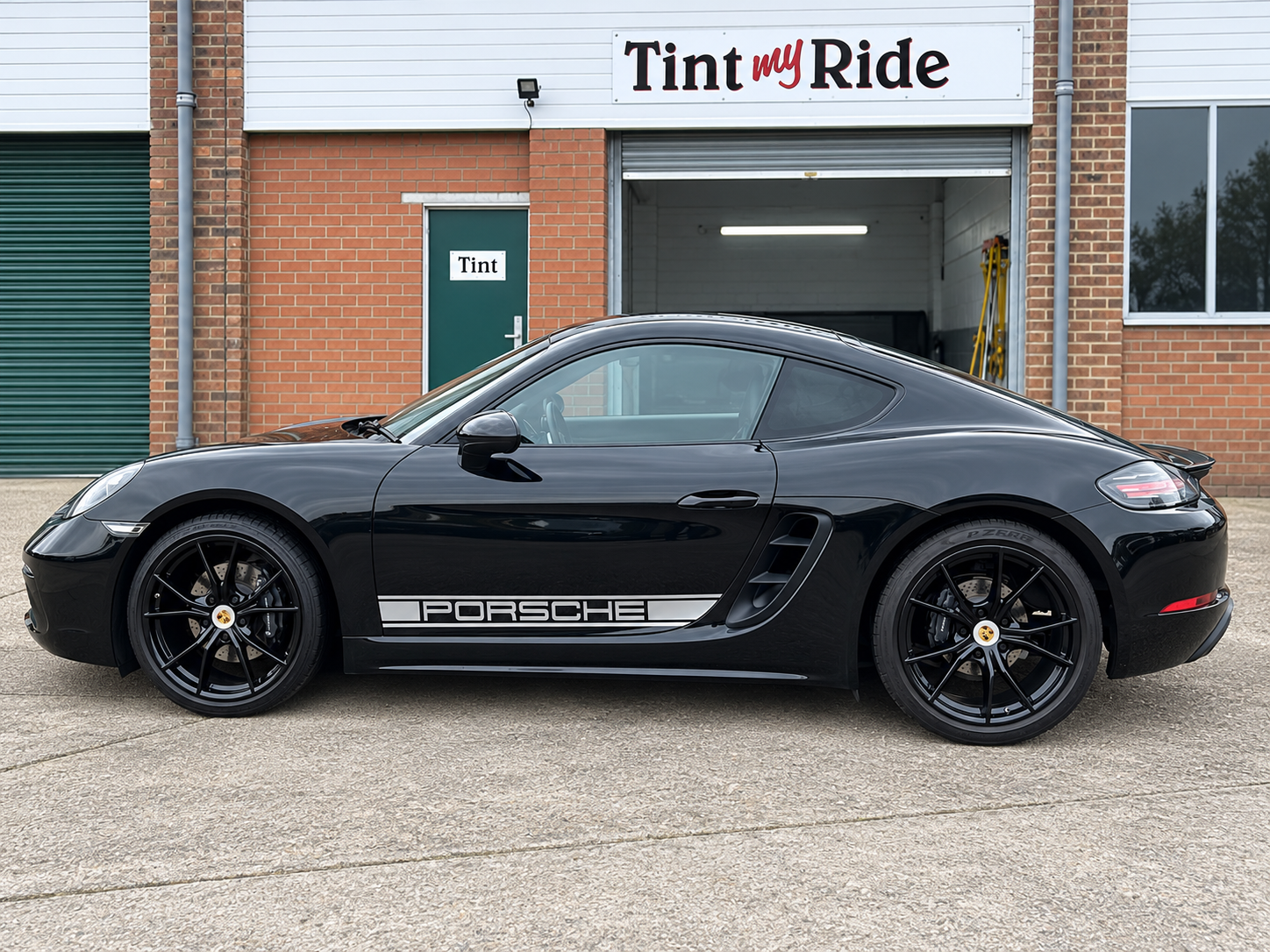 Black Porsche coupe outside Tint My Ride