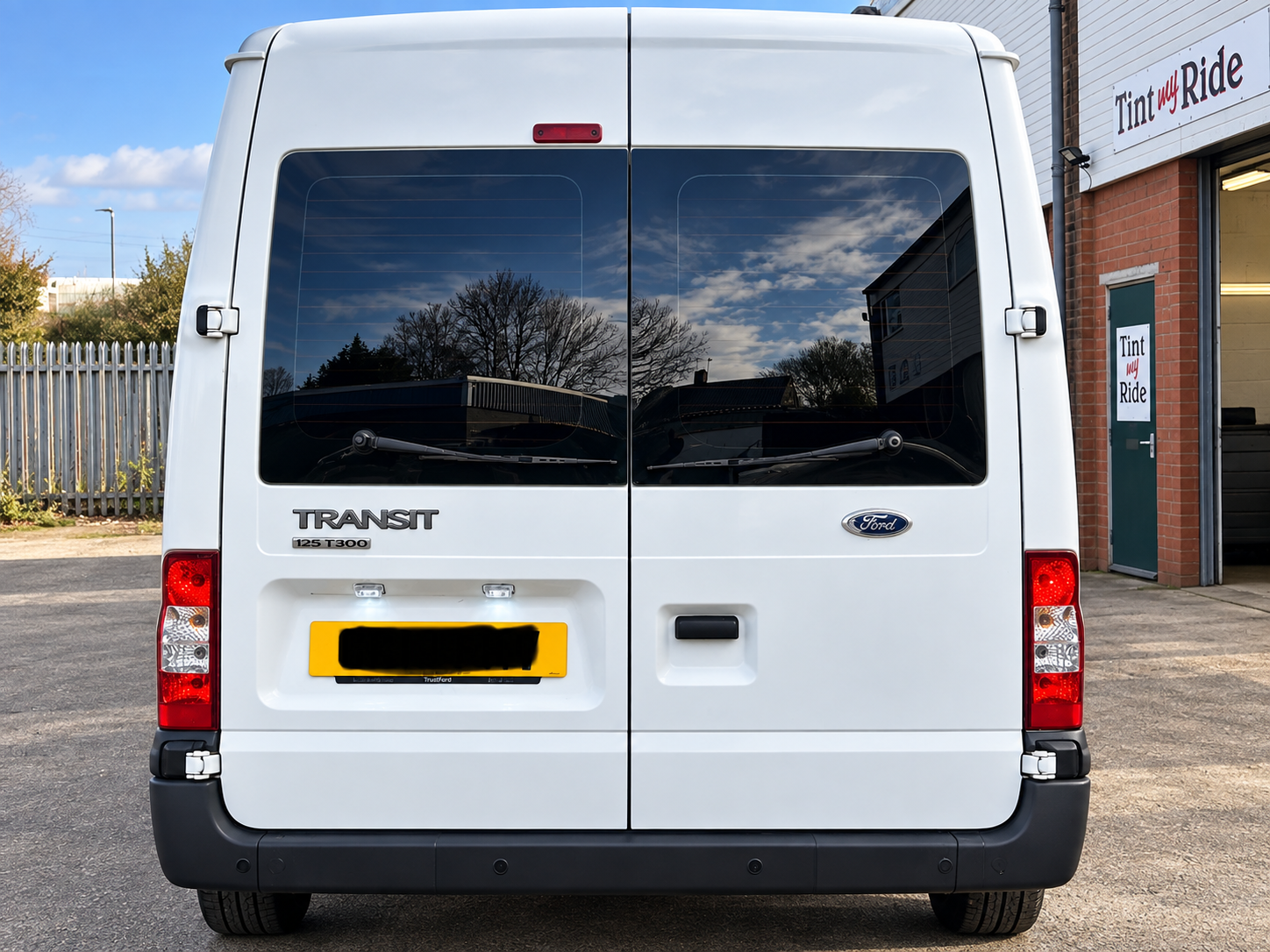 White Ford Transit with tinted rear windows