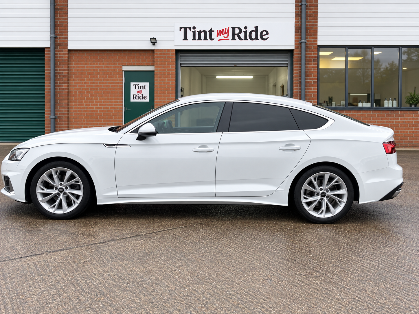 White BMW saloon with rear privacy glass