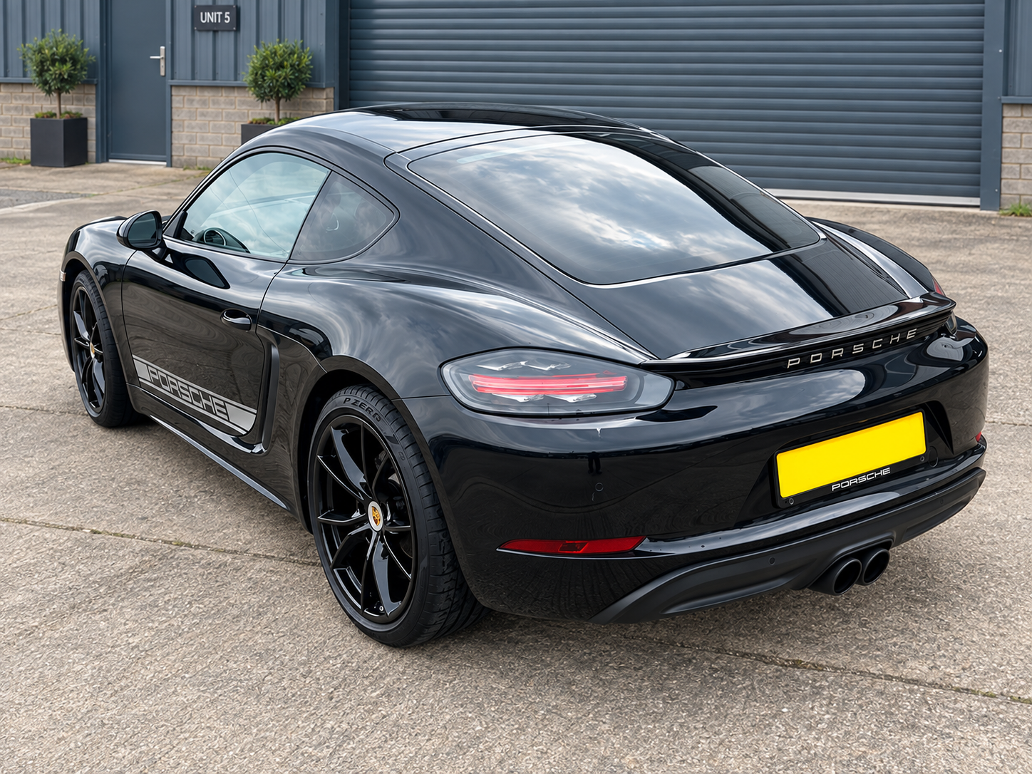 Black Porsche convertible with tinted glass