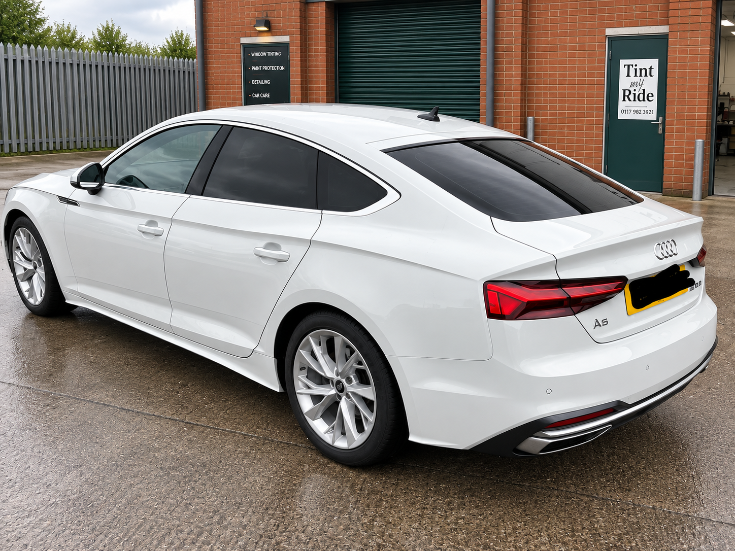 White Audi saloon with tinted rear glass