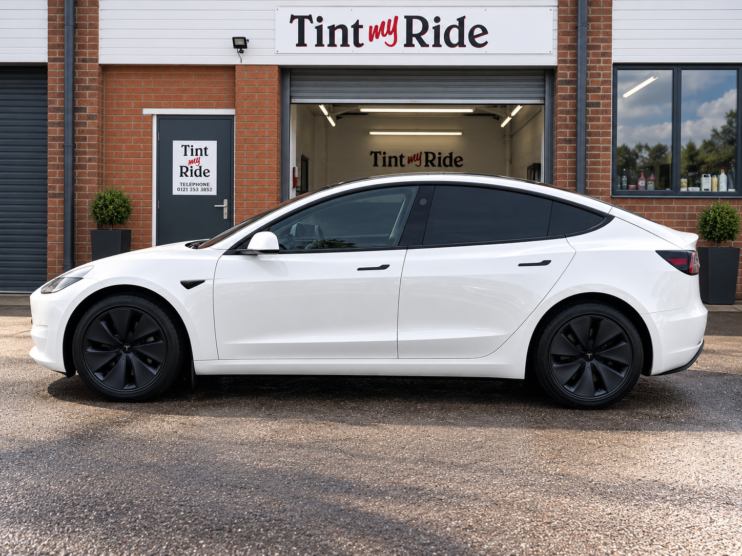 White Tesla with tinted side glass