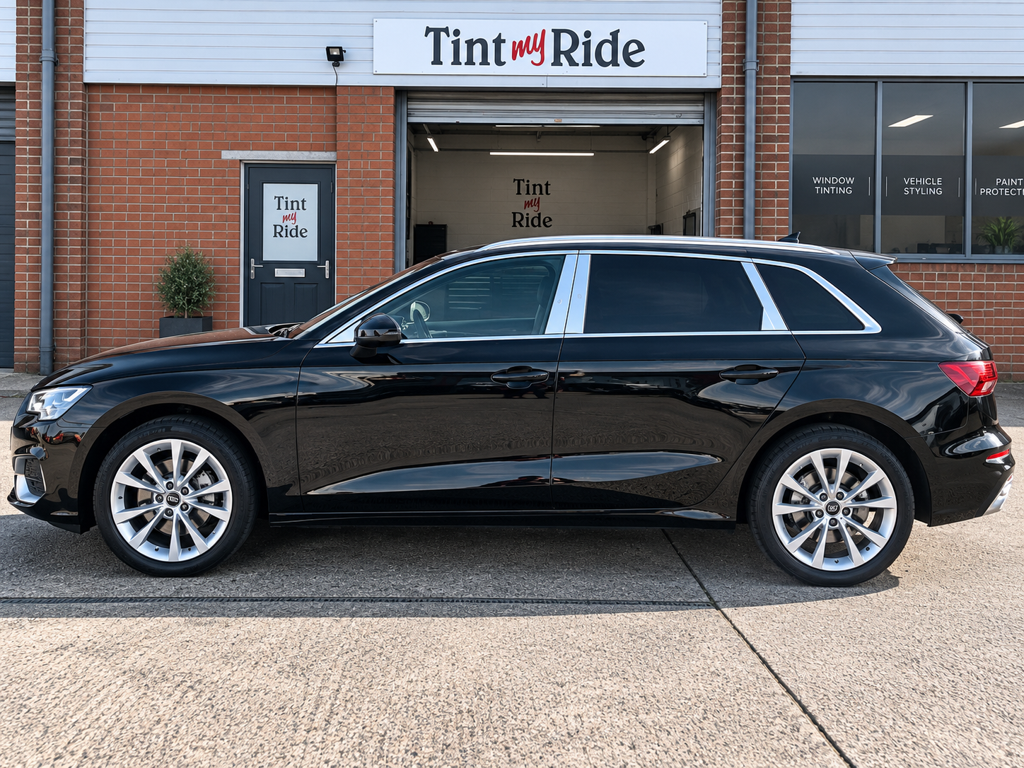 Black Audi estate with tinted rear windows