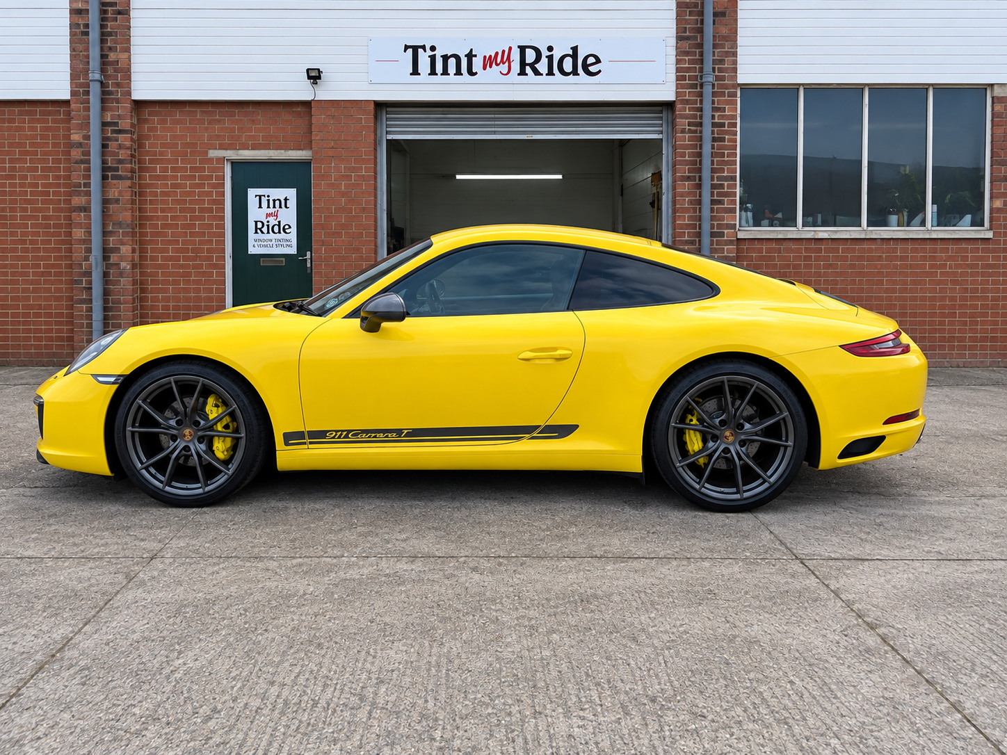 Yellow Porsche coupe outside Tint My Ride